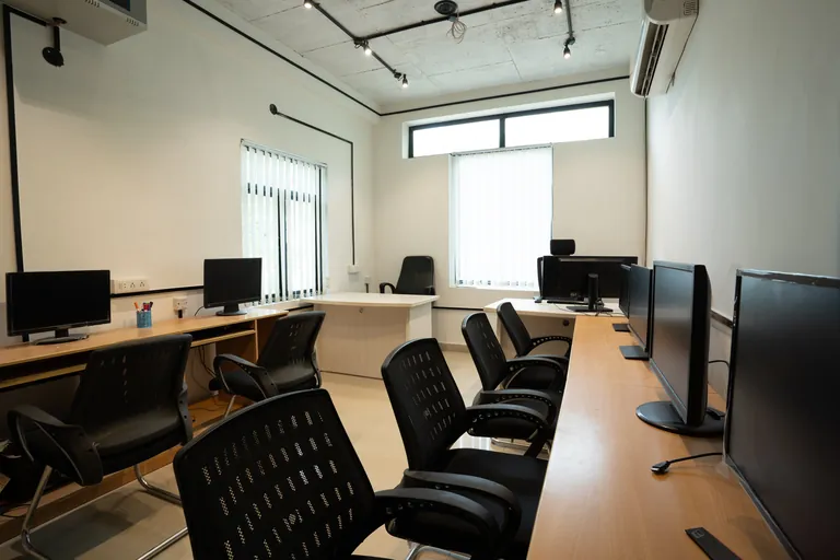 Team workstations with desktop monitors at Suits Mansarovar